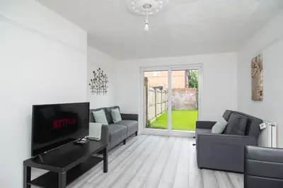 a living room with two couches and a flat screen tv at Quiet 3 bed house, pet friendly in Kirkby
