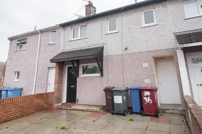 a brick house with three trash cans in front of it at Quiet 3 bed house, pet friendly in Kirkby