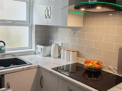 a kitchen with a sink and a bowl of oranges at Lakeside View in Southport