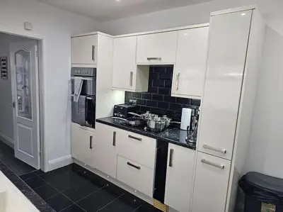 a kitchen with white cabinets and a black counter top at City Centre - Comfy 6 beds - Up to 30 percent off - Contractors delight in Liverpool