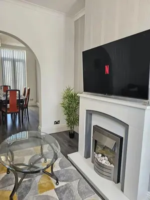 a living room with a fireplace with a tv above it at City Centre - Comfy 6 beds - Up to 30 percent off - Contractors delight in Liverpool