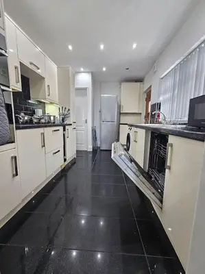 a large kitchen with white cabinets and a black floor at City Centre - Comfy 6 beds - Up to 30 percent off - Contractors delight in Liverpool