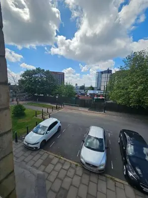 two white cars parked in a parking lot at City Centre - Comfy 6 beds - Up to 30 percent off - Contractors delight in Liverpool