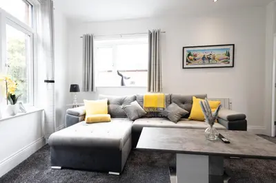 a living room with a couch and a table at Cozy Boutique Studios Perfect for Contractors & Travelers in Bolton
