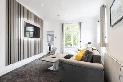 a living room with a couch and a table at Cozy Boutique Studios Perfect for Contractors & Travelers in Bolton