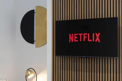 a sign on a wall with the netflix sign on it at Cozy Boutique Studios Perfect for Contractors & Travelers in Bolton