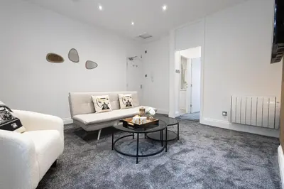 a living room with a couch and a table at Cozy Boutique Studios Perfect for Contractors & Travelers in Bolton