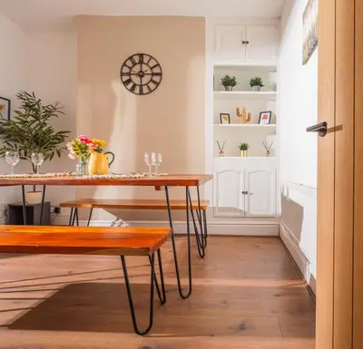 a dining room with a table and bench at Beautiful Home Away From Home - 3 Bedrooms - 6 Beds - Sleeps 7 - Free Parking in Liverpool