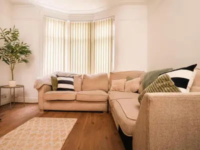 a living room with a couch and a window at Beautiful Home Away From Home - 3 Bedrooms - 6 Beds - Sleeps 7 - Free Parking in Liverpool