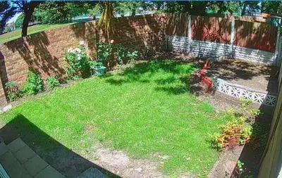 a yard with green grass and a fence at Modernised 3 Bed House in Liverpool