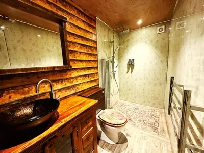 a bathroom with a shower and a toilet and a sink at Squirrel Hideaway with Hot Tub in Formby, Liverpool in Formby