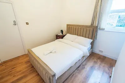 a bedroom with a bed with two towels on it at Majestic House Liverpool in Liverpool