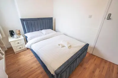 a bedroom with a bed with a white towel on it at Majestic House Liverpool in Liverpool