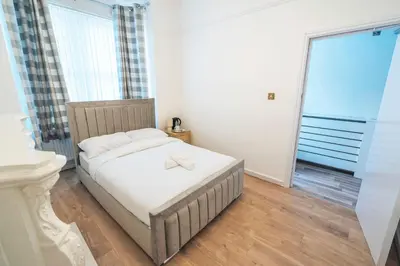 a small bedroom with a bed and a window at Majestic House Liverpool in Liverpool