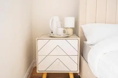 a side table with a blender on it next to a bed at Majestic House Liverpool in Liverpool