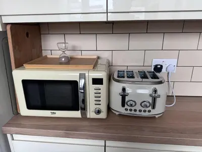 a microwave and a toaster on a kitchen counter at Four Bedroom High Spec Victorian Townhouse in Clitheroe