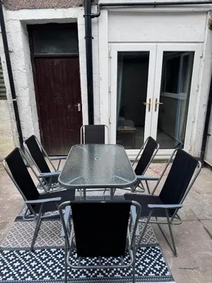 a table and chairs sitting on a patio at Four Bedroom High Spec Victorian Townhouse in Clitheroe