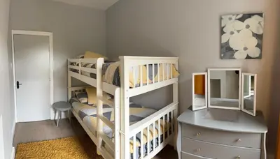 a bedroom with two bunk beds and a dresser at Four Bedroom High Spec Victorian Townhouse in Clitheroe