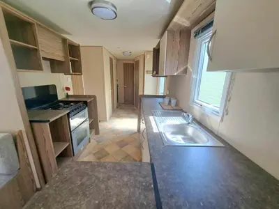 a small kitchen with a sink and a stove at Ye Old'e Man - Sleeps 6 & Pet Friendly in Grange Over Sands