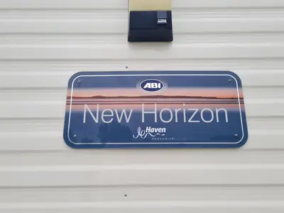 a new horizons sign hanging on a wall at Ye Old'e Man - Sleeps 6 & Pet Friendly in Grange Over Sands