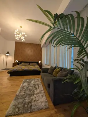 a living room with a couch and a bed at 8 Water Street in Liverpool