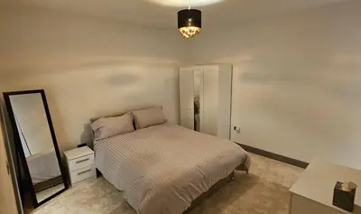 a bedroom with a bed and a dresser and a mirror at 8 Water Street in Liverpool