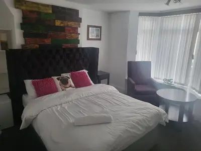 a bedroom with a bed and a table and a chair at Comfy Home in Liverpool