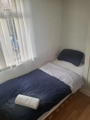 a small bedroom with a bed and a window at Comfy Home in Liverpool
