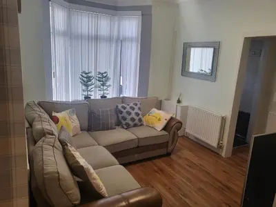 a living room with a couch and a window at Comfy Home in Liverpool