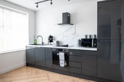 a kitchen with a sink and a stove top oven at Gynn Stays - Apartment One in Blackpool