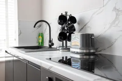 a kitchen counter with a sink and a coffee maker at Gynn Stays - Apartment One in Blackpool