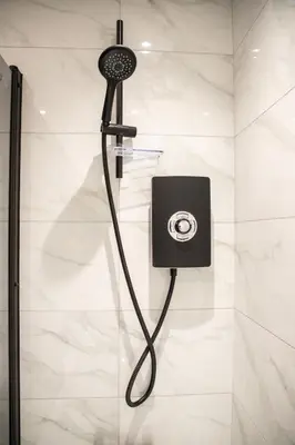 a shower with a black shower head in a bathroom at Gynn Stays - Apartment One in Blackpool