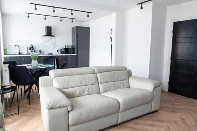 a living room with a white couch and a table at Gynn Stays - Apartment One in Blackpool