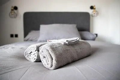 a bed with two towels on top of it at Gynn Stays - Apartment Two in Blackpool