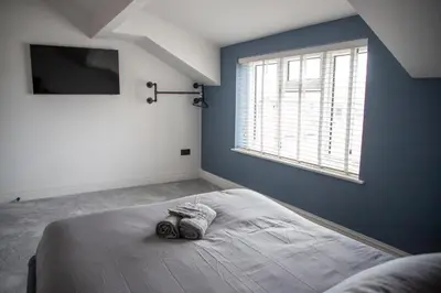 a bedroom with a large bed with a window at Gynn Stays - Apartment Two in Blackpool