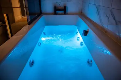 a bath tub with blue lighting in a bathroom at Gynn Stays - Apartment Two in Blackpool