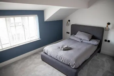 a bedroom with a large bed with a large window at Gynn Stays - Apartment Two in Blackpool