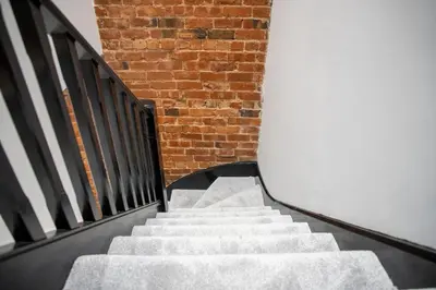 a staircase with a brick wall and a brick stair case at Gynn Stays - Apartment Two in Blackpool