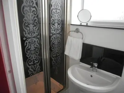 a bathroom with a toilet and a sink and a mirror at The Withnell Hotel in Blackpool