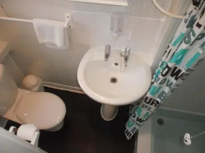 a bathroom with a white sink and a toilet at The Withnell Hotel in Blackpool