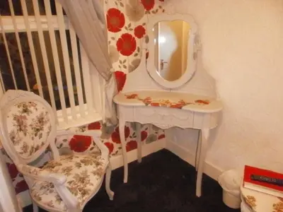 a white dressing table with a mirror and a chair at The Withnell Hotel in Blackpool