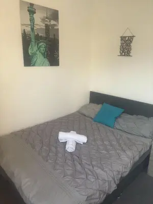 a bed with a towel laying on top of it at Fir Trees in Blackpool