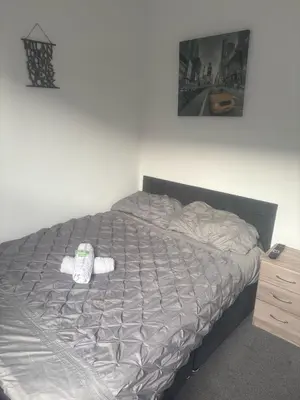 a bed in a bedroom with a pillow on it at Fir Trees in Blackpool