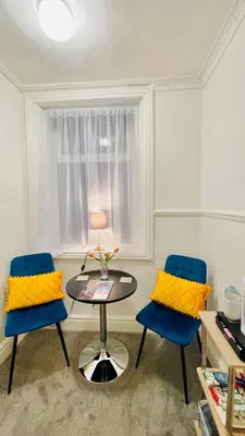 two blue chairs and a table in a room at Double Room with Private Bathroom 16 Havelock Street - 6 in Blackpool