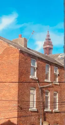 a brick building with a clock tower on top of it at Double Room with Private Bathroom 16 Havelock Street - 6 in Blackpool