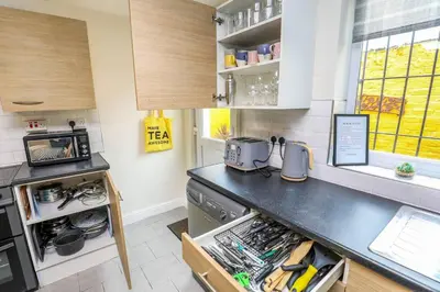 a kitchen with a counter top and a stove at Carlton Villa - Gorgeous detached home with parking in Liverpool