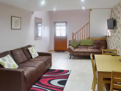 a living room with a couch and a table at Valley View - 29530 in Scotforth