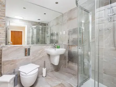a bathroom with a toilet and a sink and a shower at Mulberry House in Lytham St Annes