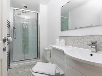 a bathroom with a toilet and a sink and a shower at Mulberry House in Lytham St Annes
