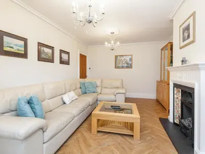 a living room with a couch and a fireplace at Mulberry House in Lytham St Annes